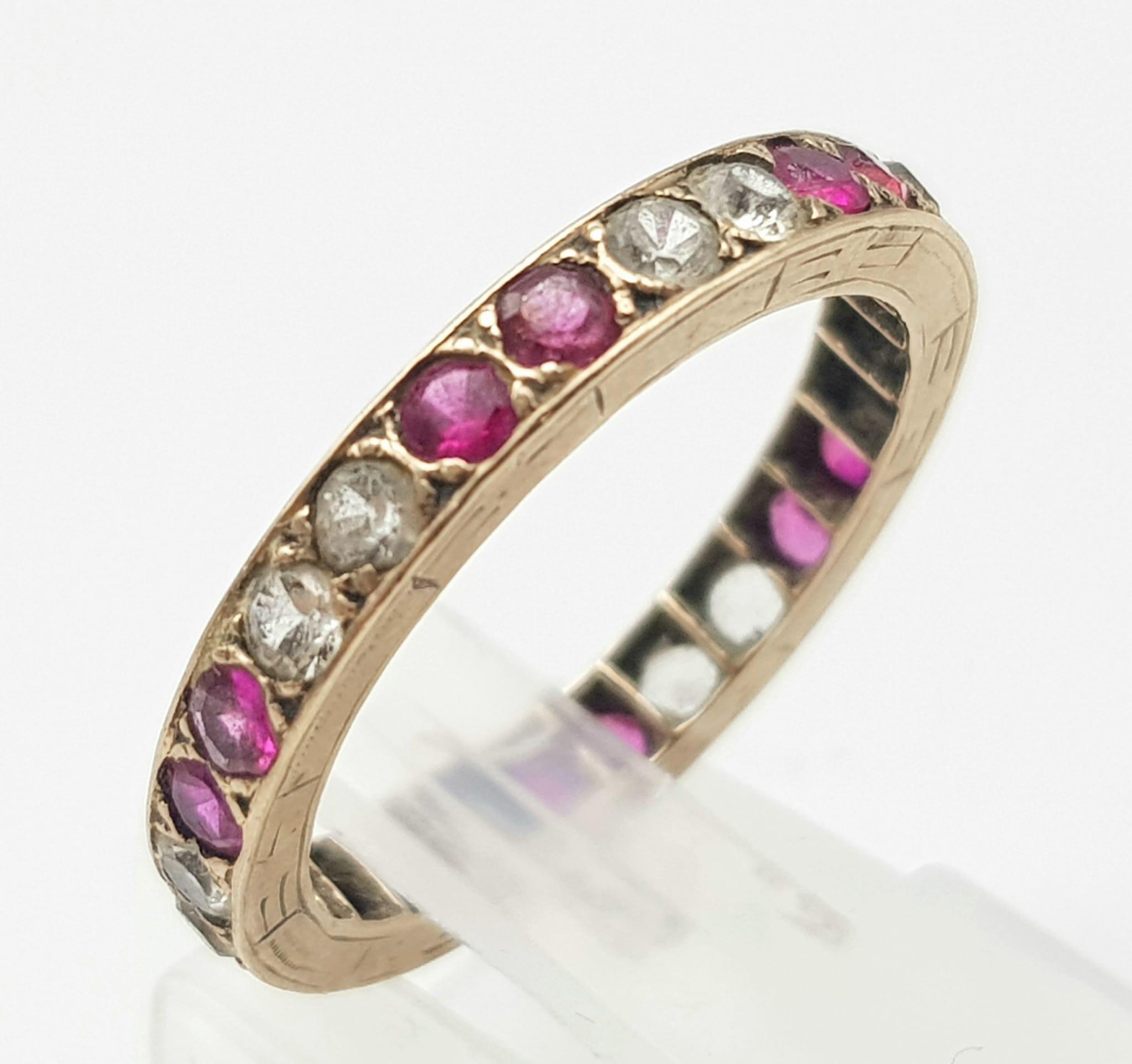 A 9K GOLD FULL ETERNITY RING WITH PINK RUBY AND WHITE SAPPHIRES , 2.1gms size N