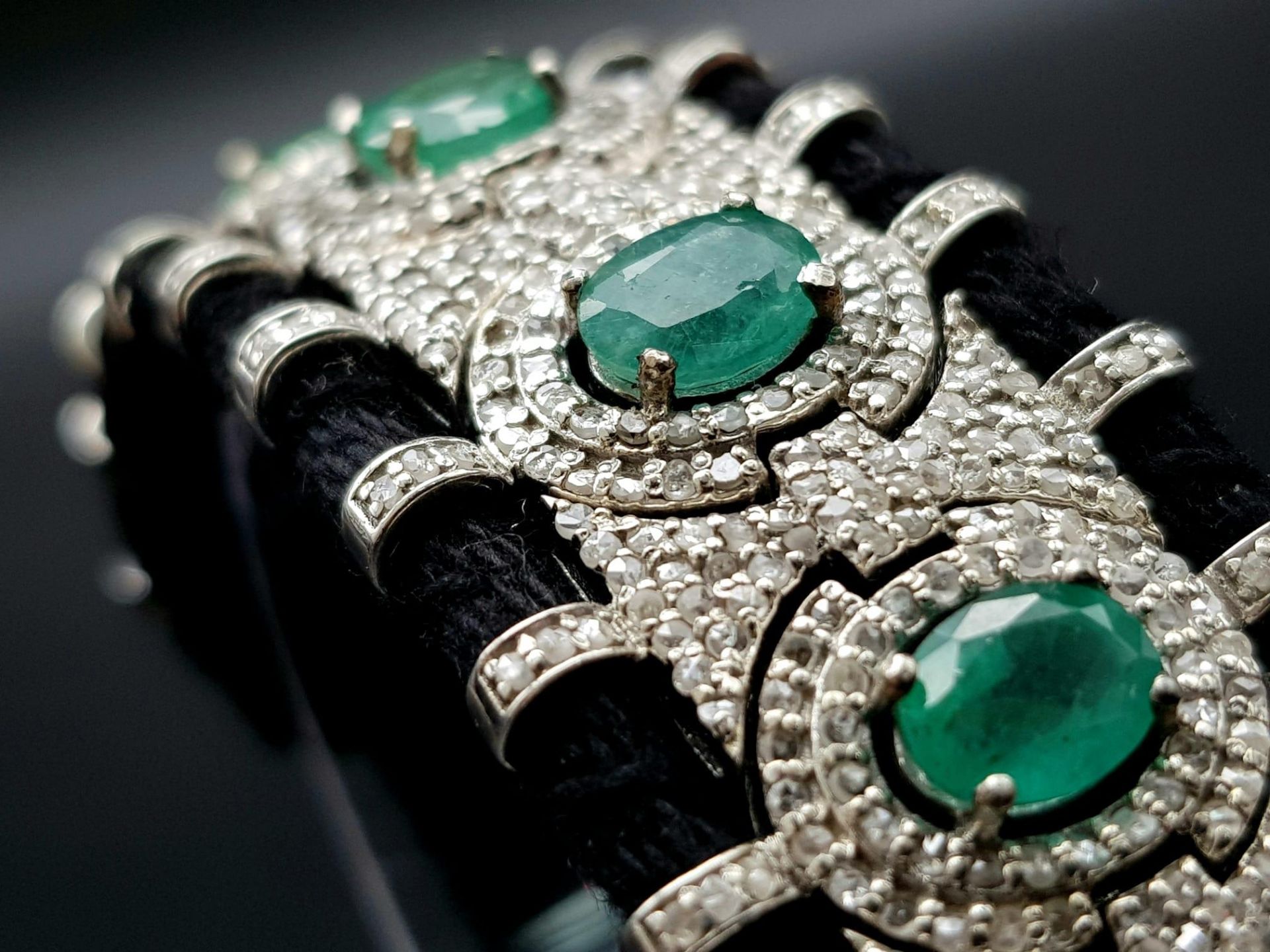 An Asian Inspired Emerald and Diamond Bracelet set in a Woven Black Textile. 10ctw of oval cut - Image 2 of 7