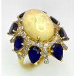 A Head-Turning Opal, Tanzanite and Diamond Ring. Centre 7ct colour-play opal with a tanzanite and