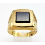 A GENTS 9K GOLD SIGNET RING WITH SQUARE BLACK ONYX CENTRE STONE AND BARKED EFFECT ON SHOULDERS . 6.