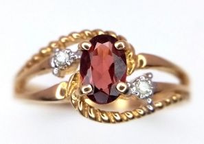 A 10k Yellow Gold Garnet and Diamond Crossover Ring. Size L. 1.86g weight.