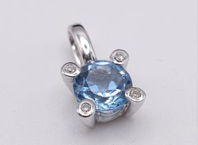 A 18K WHITE GOLD DIAMOND & BLUE TOPAZ PENDANT. TOTAL WEIGHT 1.1G