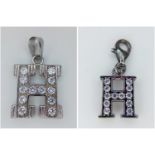 A STERLING SILVER STONE SET INITIAL H CHARM & PENDANT. 5.1G