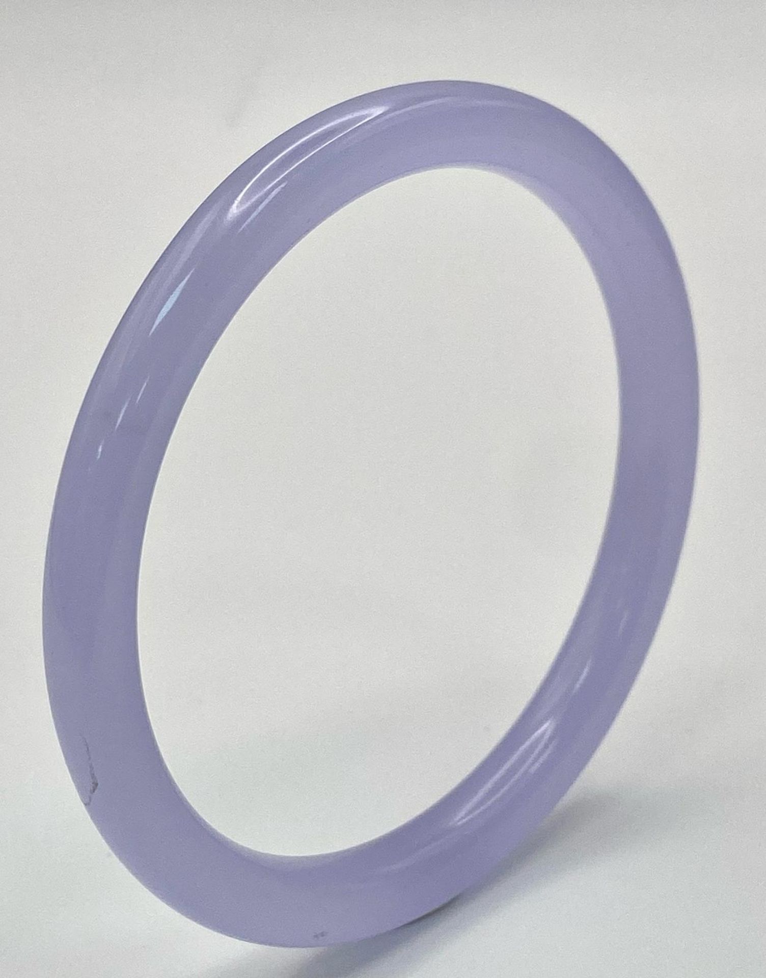 A Lilac Jade Coloured Thin Bangle. 6cm inner diameter. 8mm width.