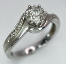 A 9K WHITE GOLD 0.25CT DIAMOND CLUSTER RING. TOTAL WEIGHT 2.4G. SIZE L