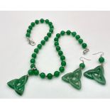 A quality green jade necklace with pendant and earrings in an “eternal triangle” design