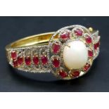 A Wonderful Majestic Colour-Play 12ct Opal and Ruby Gemstone Cuff Bracelet with Diamond Accents.
