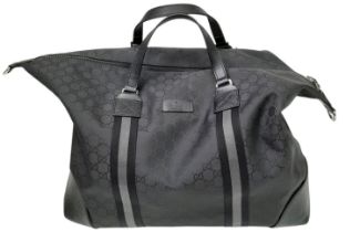 A Gucci Black GG Guccissima Duffle Bag. Textile exterior with silver-toned hardware, two leather