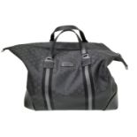 A Gucci Black GG Guccissima Duffle Bag. Textile exterior with silver-toned hardware, two leather