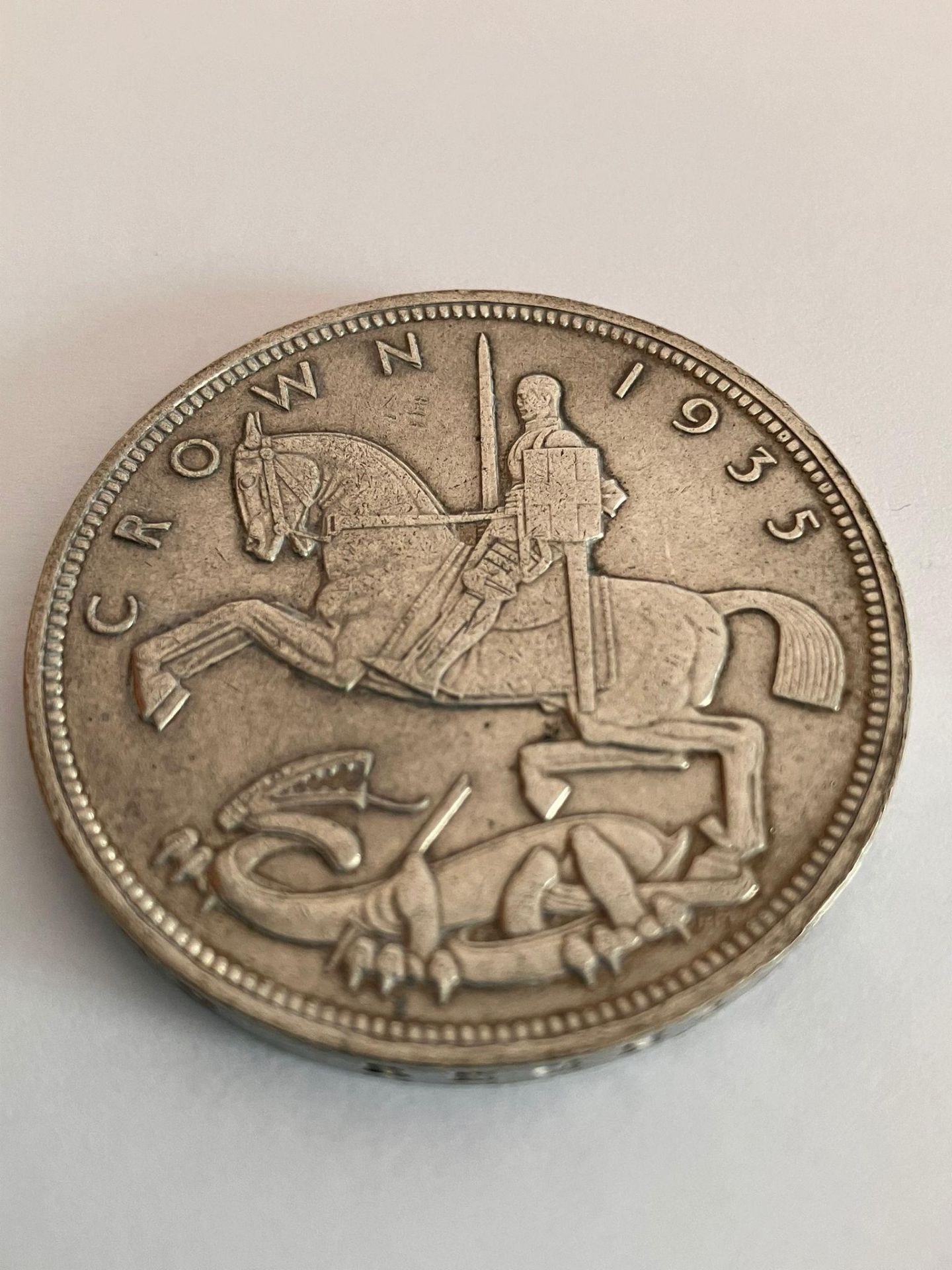 1935 SILVER ROCKING HORSE CROWN. Extra fine condition. Having raised bold definition to both