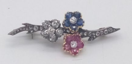 AN VICTORIAN DIAMOND , SAPPHIRE AND RUBY BROOCH IN FLORAL FORM AND SET IN GOLD AND PLATINUM . 4cms