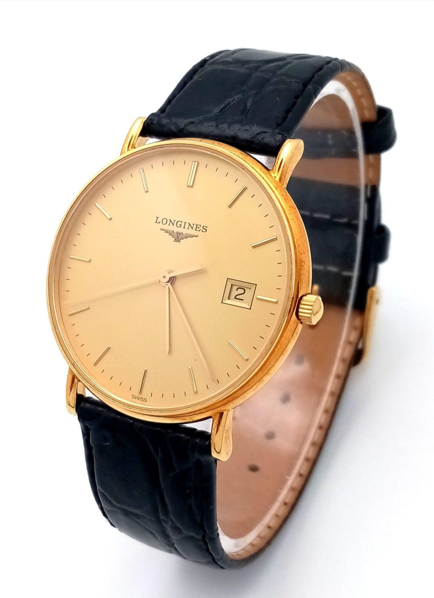 A Longine 18K Gold Cased Gents Watch. Black leather strap. 18k gold case - 33mm. Gilded dial with