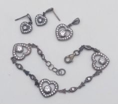 A collection of vintage 925 silver CZ cluster heart jewellery include a pair of drop earrings, a