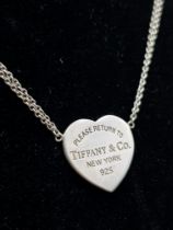 A Sterling silver Tiffany and Co double chain necklace with engraved heart pendant. Comes complete