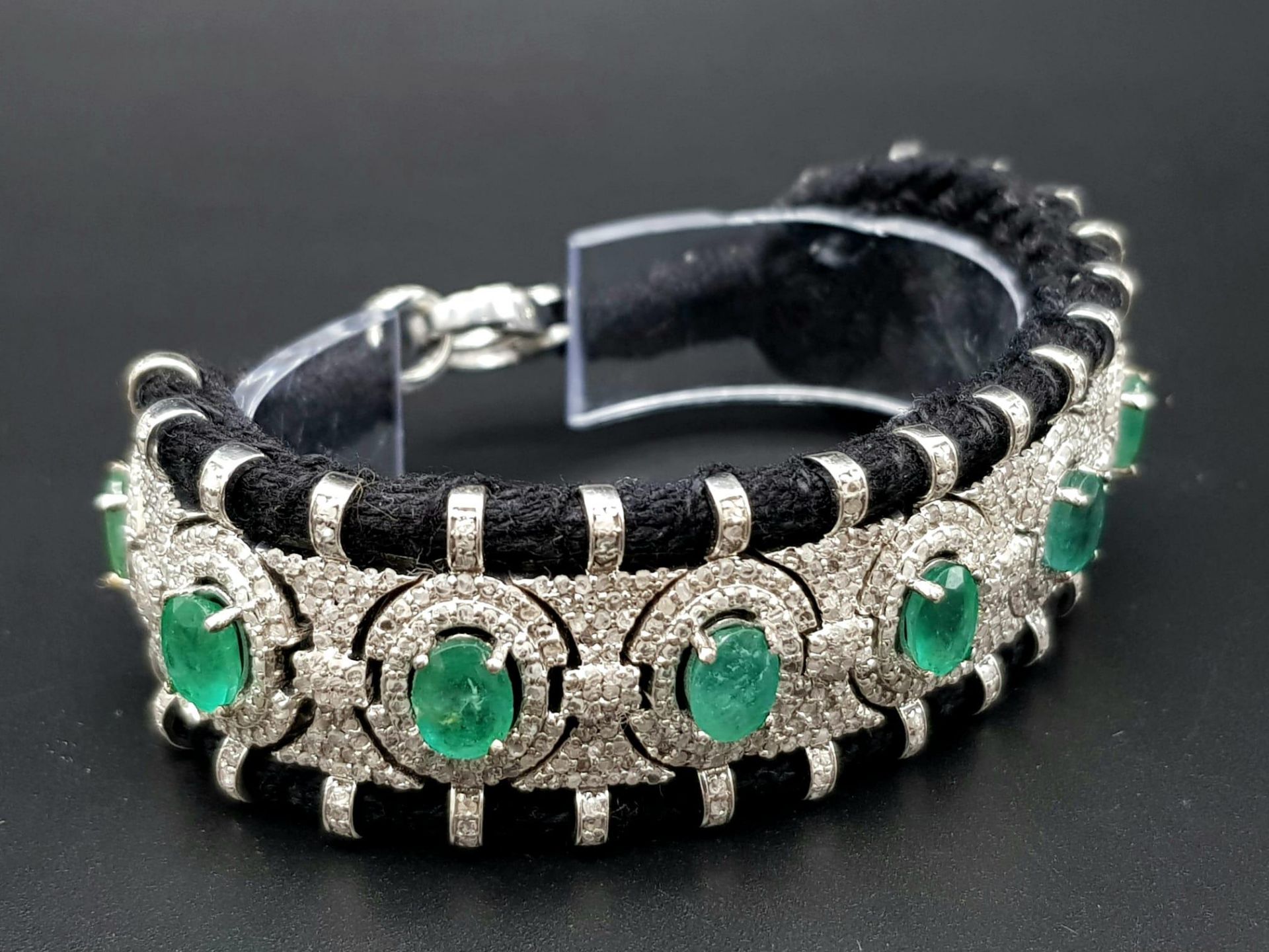 An Asian Inspired Emerald and Diamond Bracelet set in a Woven Black Textile. 10ctw of oval cut - Image 3 of 7