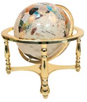 A Mother of Pearl Gemstone Globe. Gilded metal stand. 43cm x 50cm. In good condition.
