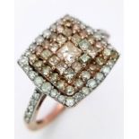 A FANCY 9K ROSE GOLD 0.60CT DIAMOND CLUSTER RING. TOTAL WEIGHT 2.1G. SIZE L 1/2