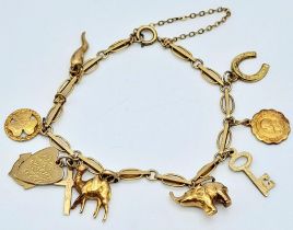 A 9K Yellow Gold Charm Bracelet. Eight charms including Elephant! 10.65g weight.