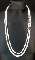 A Long Double Row Cultured Pearl Necklace with a Silver CC Clasp. 80cm length.