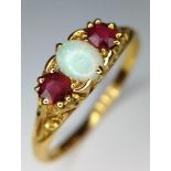 A VINTAGE 18K YELLOW GOLD OPAL & RED STONE RING. TOTAL WEIGHT 3.1G. SIZE S