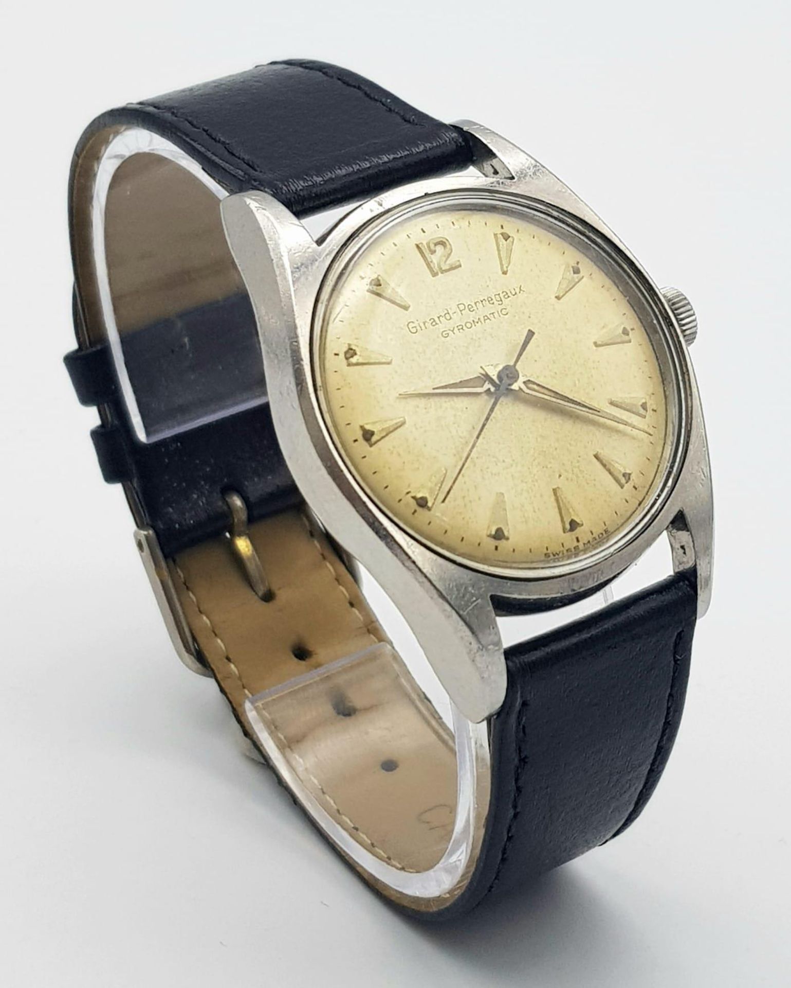 A VINTAGE GIRARD-PERREGAUX "GYROMATIC" MID SIZE WATCH , MANUAL WIND AND ON A BLACK LEATHER STRAP .