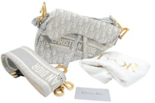 A Christian Dior Grey Saddle Bag, Gold tone hardware and Dior letter charm, comes with the