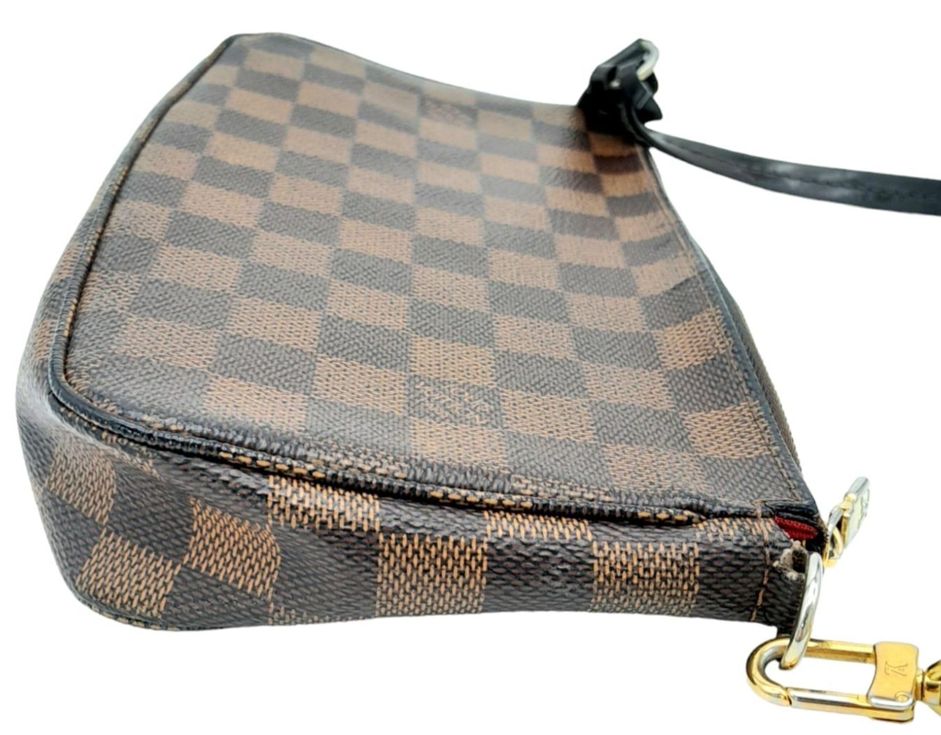 A Louis Vuitton Damier Ebene Pochette with Leather Exterior. Top Zip Closure. Red Fabric Lining with - Image 3 of 7