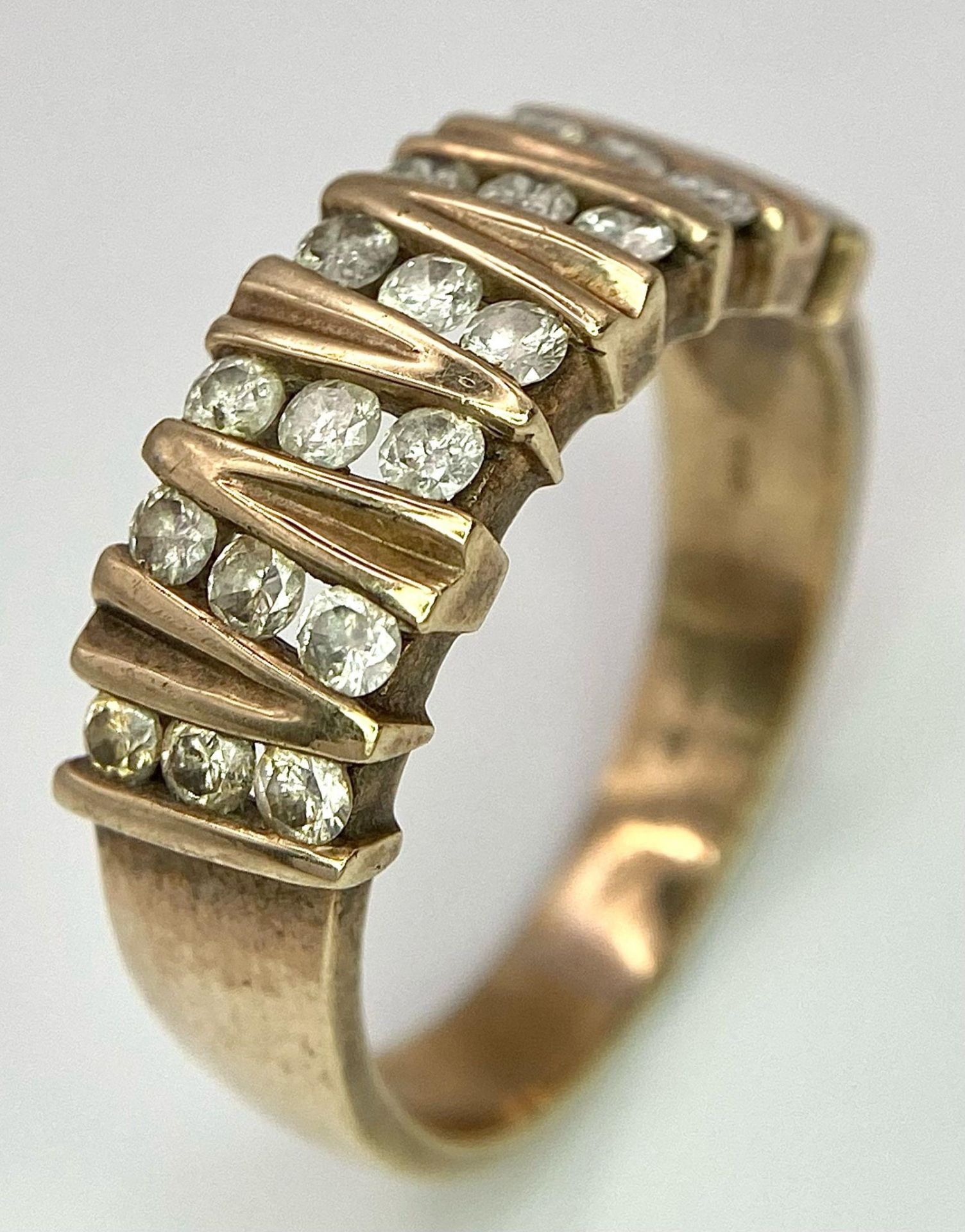 A Vintage 9K Yellow Gold 21 Diamond Ring. 1ctw of brilliant round cut diamonds. Size T. 5.9g total