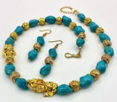 A glamorous necklace and matching earrings set with turquoise nuggets, gold filled “Good Luck” beads