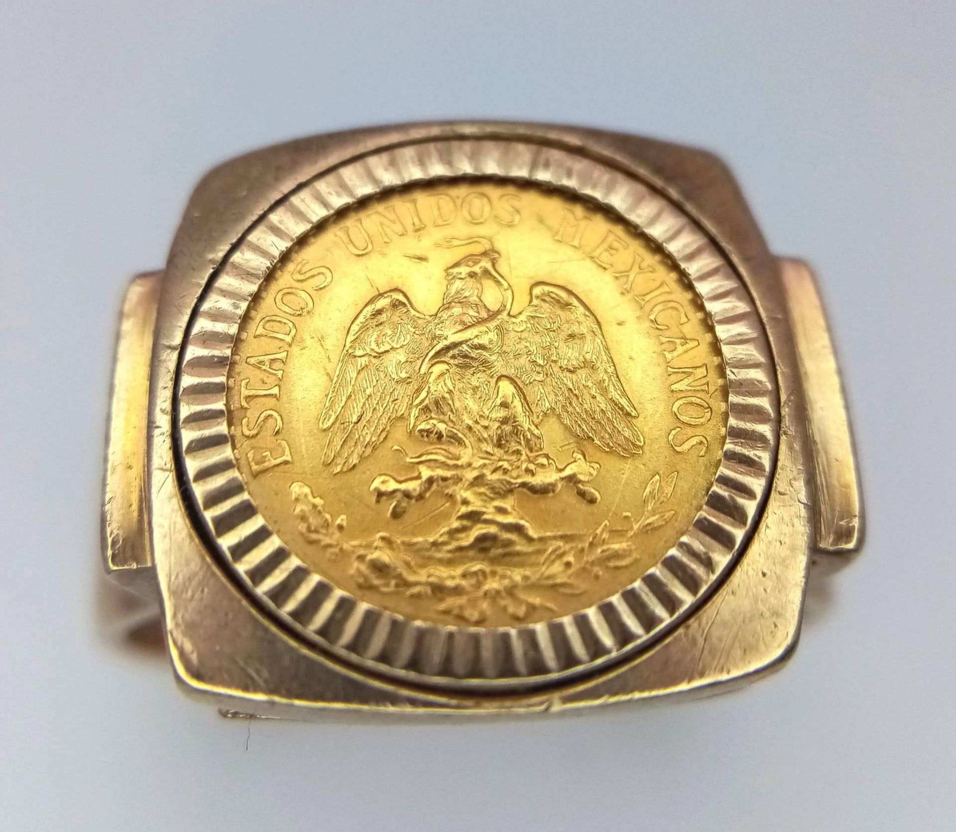 An 18K Gold Dos Pesos Mexican Coin set in a 9K Gold Ring. 6.6g total weight. Size R.