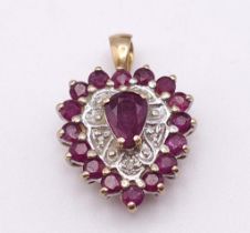 A 9K YELLOW GOLD DIAMOND & RUBY HEART PENDANT. TOTAL WEIGHT 2G