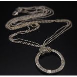 A sterling silver triple chain necklace with a magnifying glass holder pendant decorated with