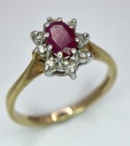 A 9K YELLOW GOLD DIAMOND & RUBY CLUSTER RING. TOTAL WEIGHT 1.7G. SIZE K