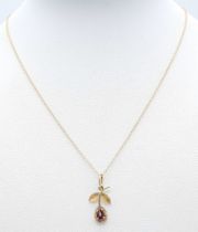 A fancy 9K yellow gold Garnet flower pendant on delicate gold chain. Total weight 1.1G. Total length