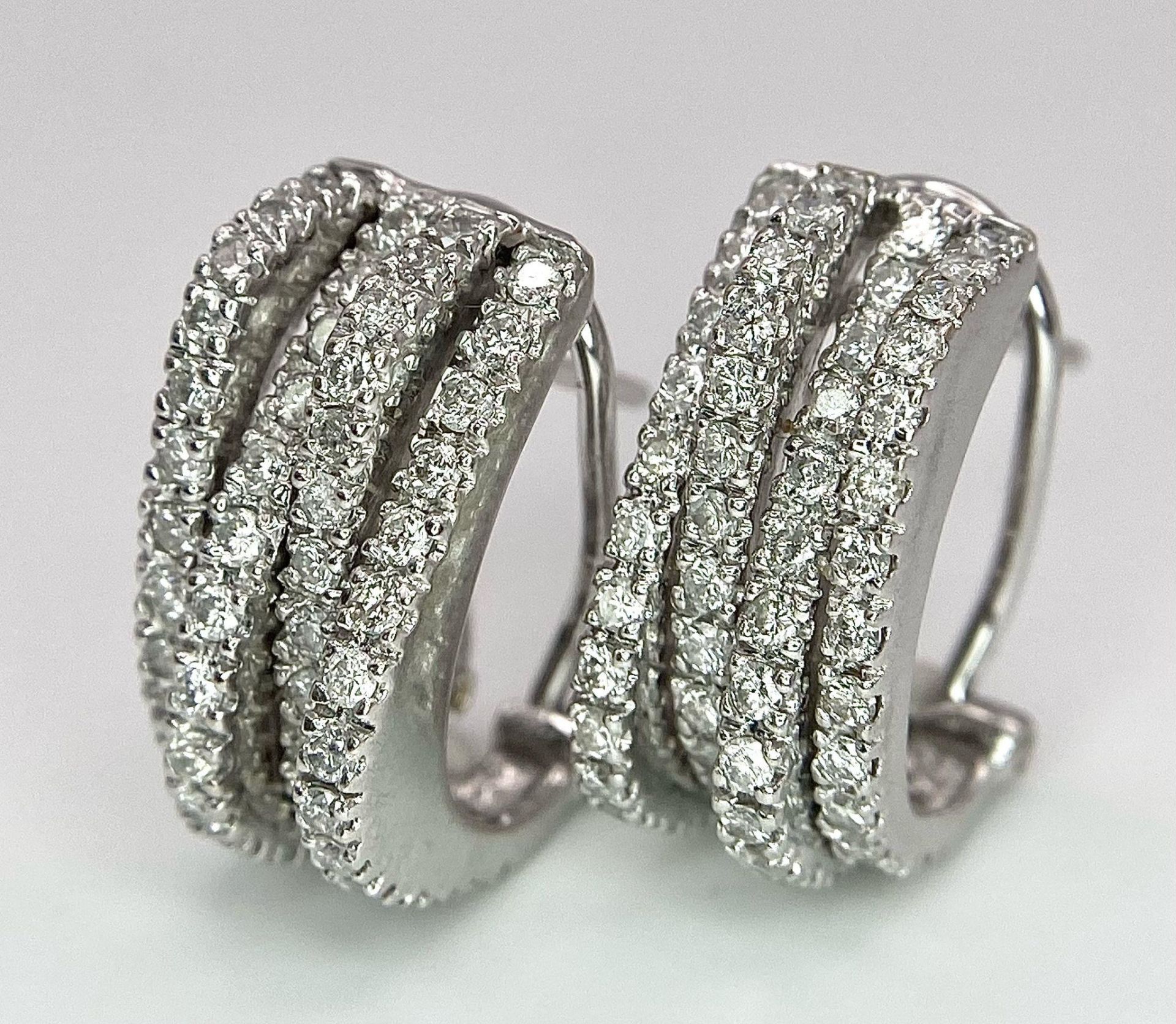 A PAIR OF 18K WHITE GOLD DIAMOND EARRINGS. TOTAL WEIGHT 9.8G