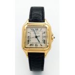 A Cartier Panthere 18K Gold Ladies Watch. Black leather strap and 18k gold clasp. 18k gold case -