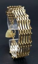 A 9K GOLD 8 GATE BRACELET WITH HEART PADLOCK AND SAFETY CHAIN . 12.6gms