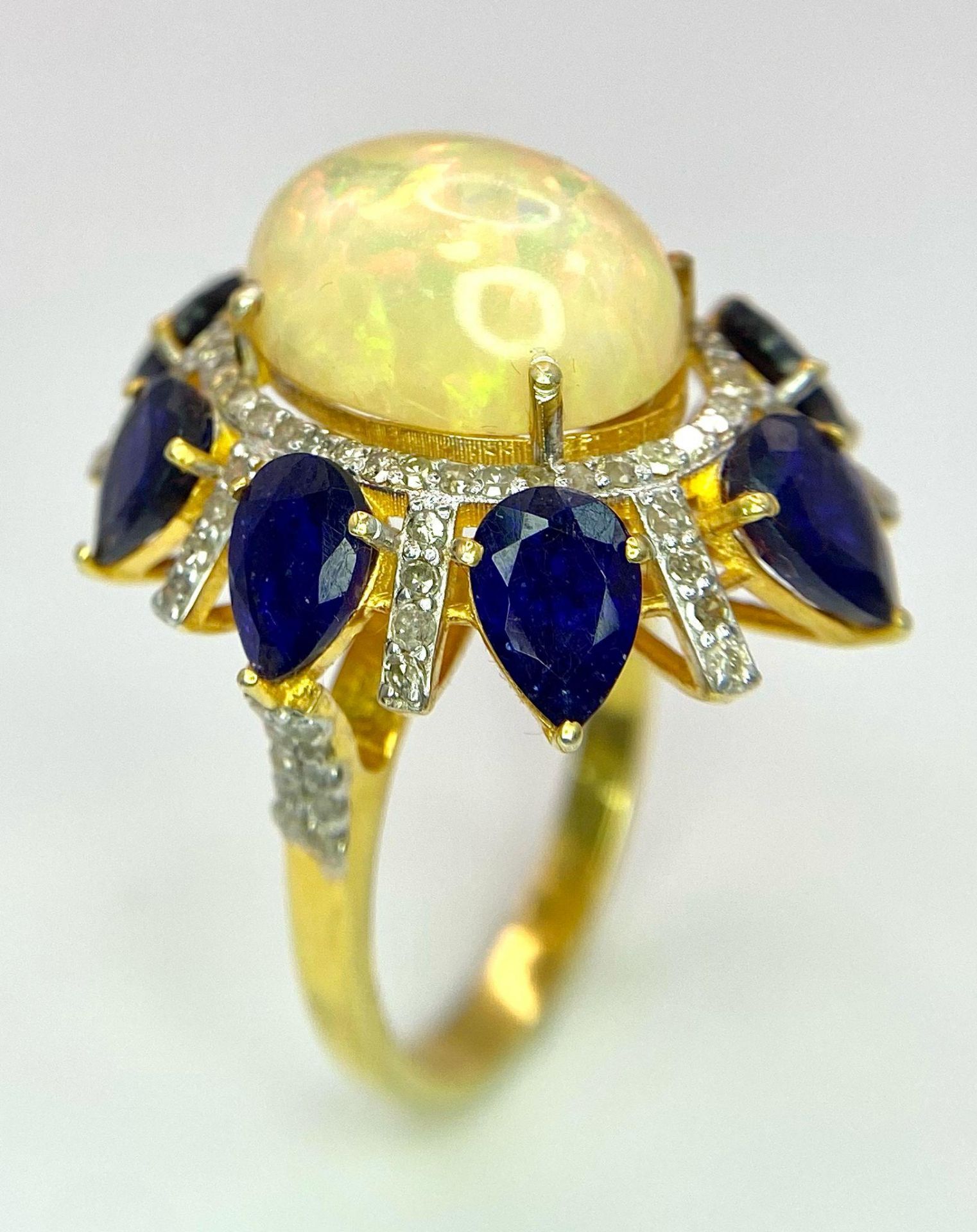 A Head-Turning Opal, Tanzanite and Diamond Ring. Centre 7ct colour-play opal with a tanzanite and - Image 2 of 6