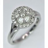 A 9K WHITE GOLD 0.50CT DIAMOND CLUSTER RING. TOTAL WEIGHT 2.8G. SIZE I