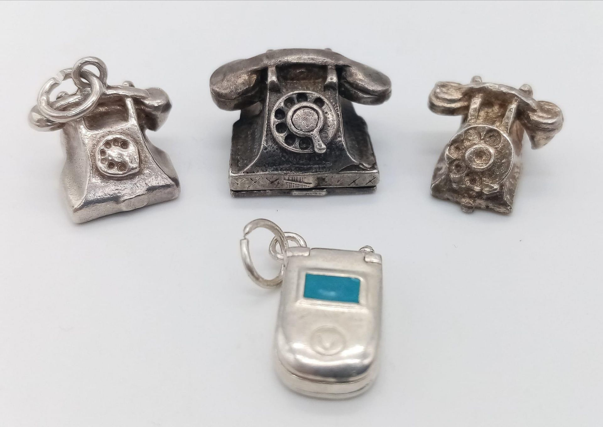 4 X STERLING SILVER TELEPHONE CHARMS - 3 OLD SCHOOL PHONES AND A FLIP MOBILE. 14.5G