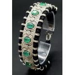 An Asian Inspired Emerald and Diamond Bracelet set in a Woven Black Textile. 10ctw of oval cut