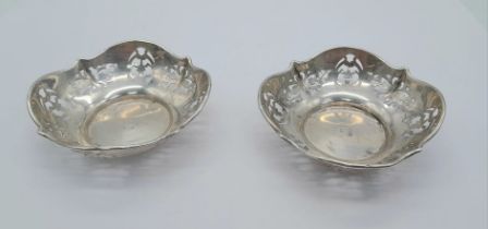 A PAIR OF PIERCED SILVER DISHES DATED 1946 . 7.5cms DIAMETER 36.2gms