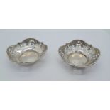 A PAIR OF PIERCED SILVER DISHES DATED 1946 . 7.5cms DIAMETER 36.2gms