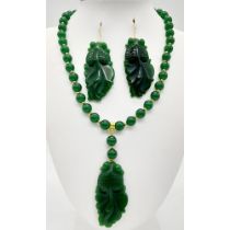 A Chinese, green jade necklace and earrings set with large fancy tailed fish pendants, symbolising