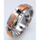 An 18K White and Rose Gold Gents Band Ring - With an eternal setting of six blue topaz stones.