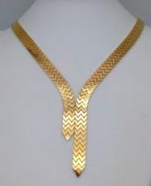 An Elegant 18K Gold Flat Scale Link Necklace with Twin Tassel Extenders. 48cm length. 35.25g weight.