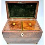 A GEORGIAN WALNUT TEA CADDY WITH BRASS BALL FEET AND ORNATE RING HANDLES , TWIN TEA COMPARTMENTS .