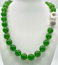 A Fabulous Chinese Green Jade Bead Necklace with a Baroque Pearl Interrupter. 12mm jade beads. Fancy