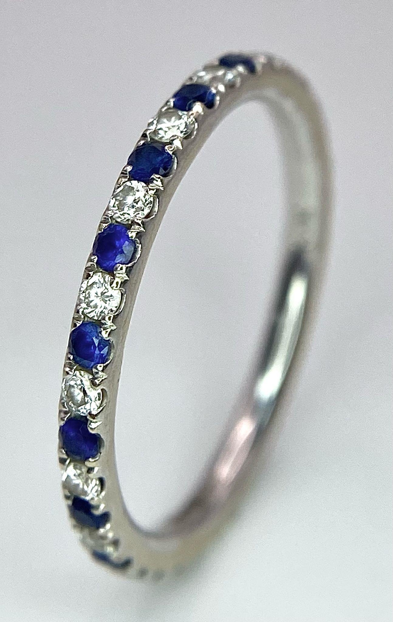 A 14ct white gold diamond and sapphire full eternity ring set with 18 diamonds and 18 sapphires, 1.
