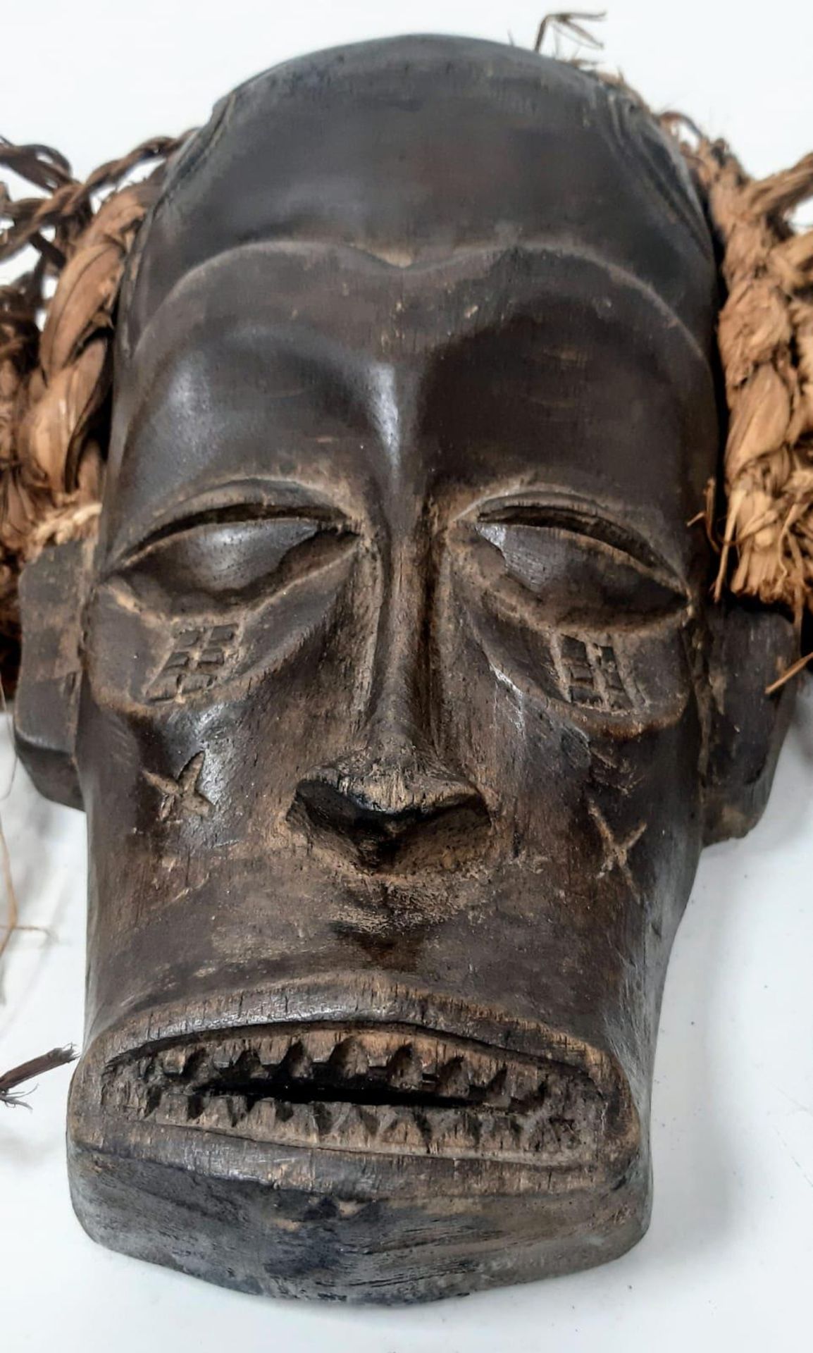 An antique Maasai wooden mask of a young warrior with red long “hair”. In very good condition for - Image 2 of 4